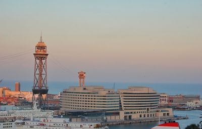 Tower in city at sunset