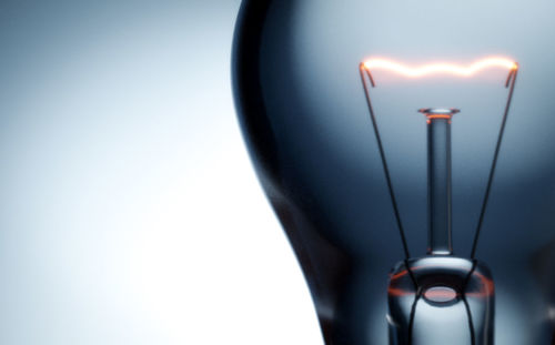 Close-up of illuminated lamp against white background