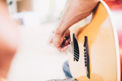 Close-up of man playing guitar