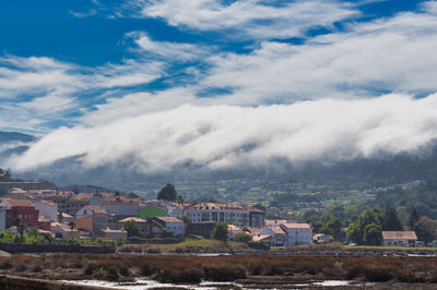 A sea of white clouds going down the mountains to the village of noia in galicia, spain