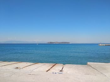 Scenic view of sea against clear blue sky