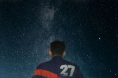 Rear view of man against star field