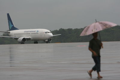 Side view of two people walking in airplane