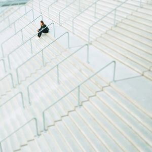 High angle view of woman sitting on staircase