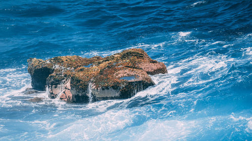High angle view of rock formation in sea