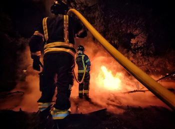 Rear view of man standing on railroad track