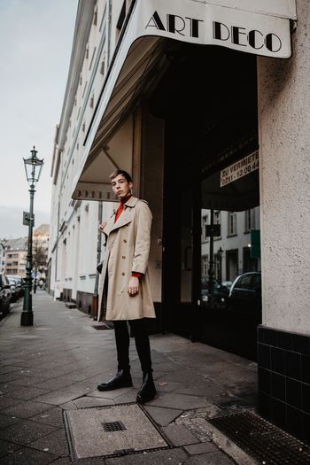 FULL LENGTH OF MAN STANDING ON SMART PHONE