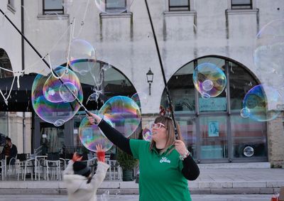 Full length of woman with bubbles in background