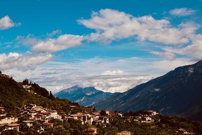 Town by mountains against sky