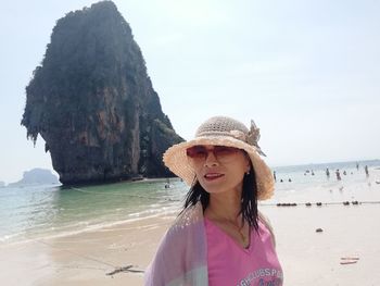 Woman at beach against sky