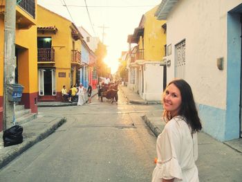 Portrait of woman standing in city