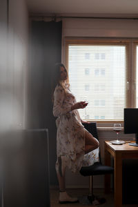 Woman sitting on table at home