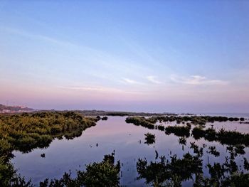 Scenic view of lake against sky during sunset