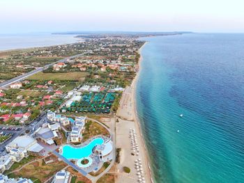 High angle view of city by sea against sky summer hotels and houses near the beach from a drone 