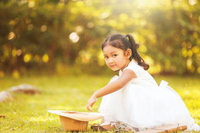 Cute girl sitting outdoors