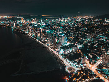 High angle view of city lit up at night