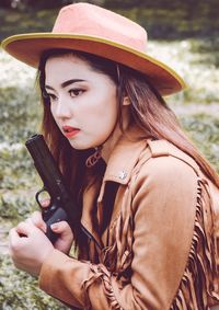 Portrait of young woman wearing hat