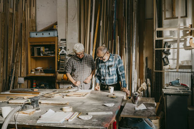 Senior craftsmen working together at carpentry workshop