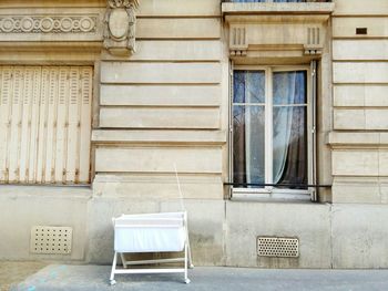 Abandoned baby carriage outside building