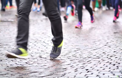 Low section of people walking on street