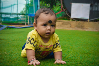 Portrait of cute baby boy on garden 