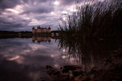 Reflection of building in lake at sunset