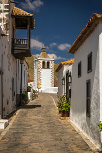 Alley amidst buildings against sky, fuerteventura 