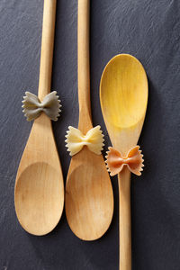 Directly above shot of farfalle pastas on spoons