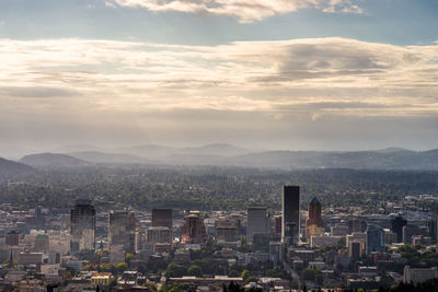 High angle view of buildings and mountains against sky