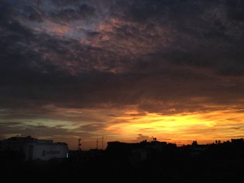 Silhouette of built structure against dramatic sky