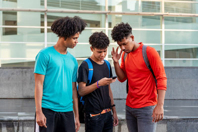 Group of people standing on mobile phone