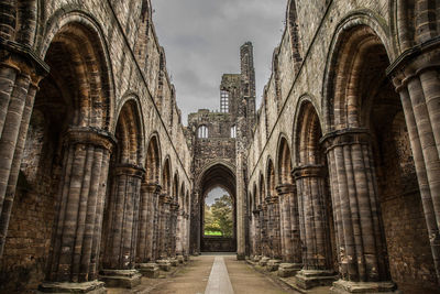 Archway of historic building against sky