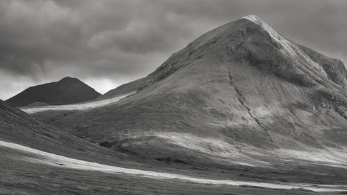 View of volcanic mountain against cloudy sky