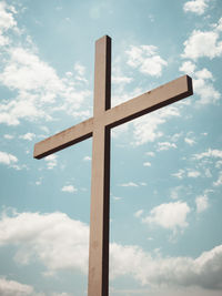 Low angle view of cross sign against sky