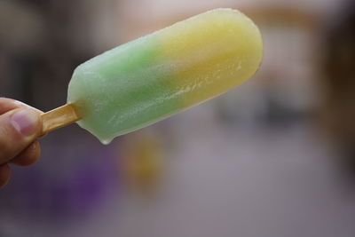 Close-up of hand holding ice cream cone