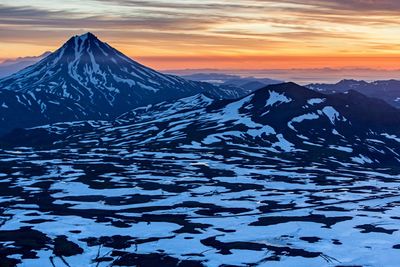 Scenic view of snow mountains against sky during sunset