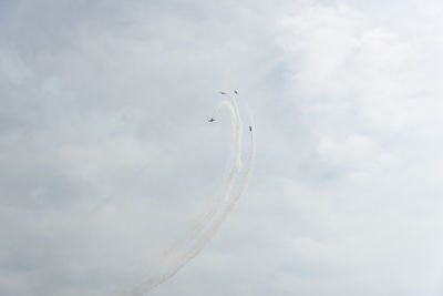 Low angle view of airplane flying against sky