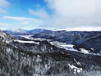 Scenic view of snowcapped mountains against sky