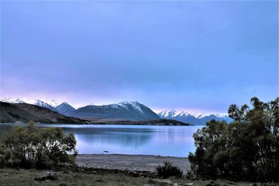 Scenic view of lake and mountains against sky