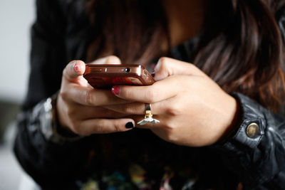 Cropped image of man photographing through smart phone