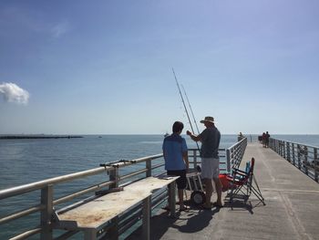 Tourists on pier at sea