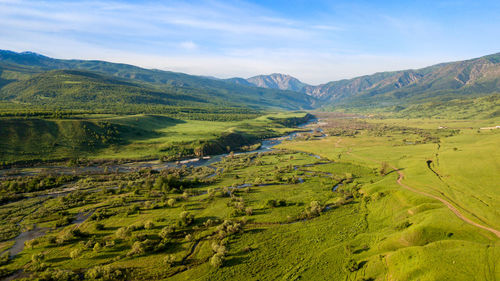 Scenic view of landscape and mountains against sky