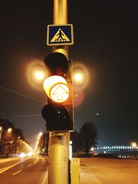 Close-up of road sign at night