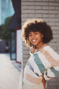 Portrait of smiling young woman standing outdoors