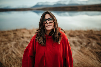 Portrait of beautiful young woman standing on land