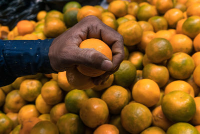 Close-up of hand holding fruits at market