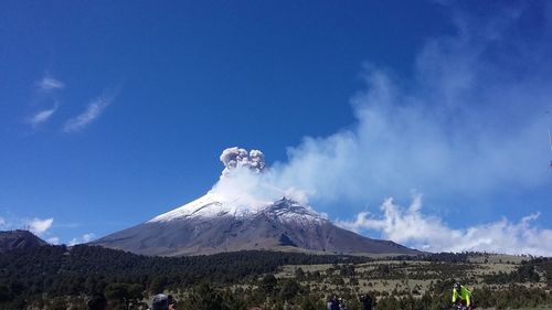 Panoramic view of volcanic landscape against blue sky