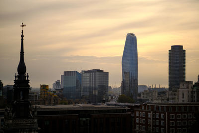 London, uk. tower of the former st. augustine church with skyscrapers in the background.