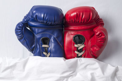 High angle view of boxing gloves on bed