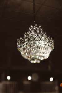 Low angle view of illuminated pendant lights hanging from ceiling